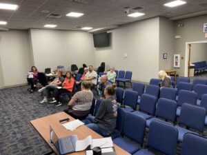 Board and committee members seated at a meeting in the council chambers