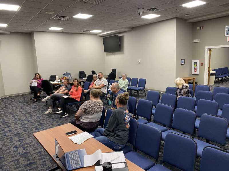 Board and committee members seated at a meeting in the council chambers