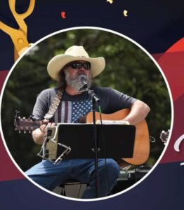 Musician in a cowboy hat playing guitar at Farmers Market Friday
